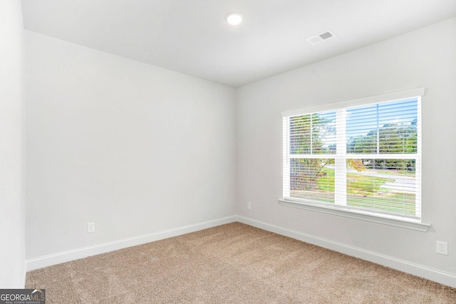 unfurnished room featuring carpet