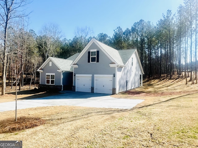 view of side of property with a garage and a yard