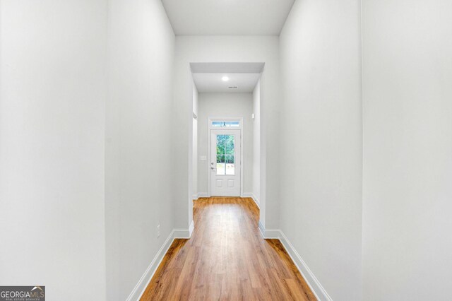 corridor with light wood-type flooring