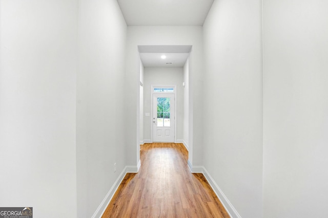 corridor with hardwood / wood-style floors