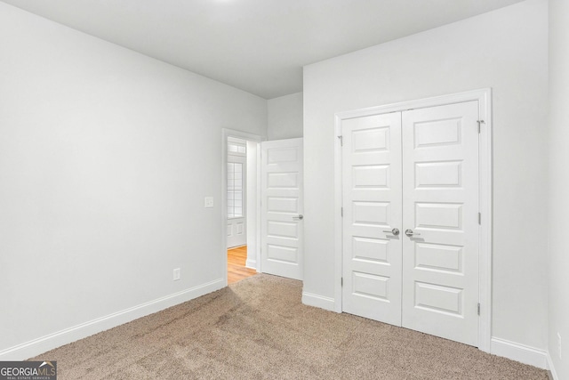 unfurnished bedroom with carpet floors and a closet