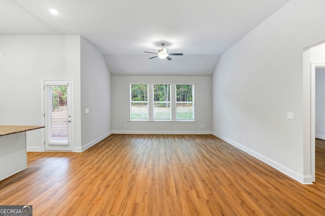 unfurnished living room with vaulted ceiling, ceiling fan, and light hardwood / wood-style floors