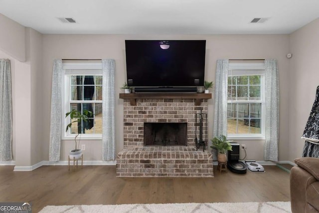 living room with wood-type flooring and a fireplace