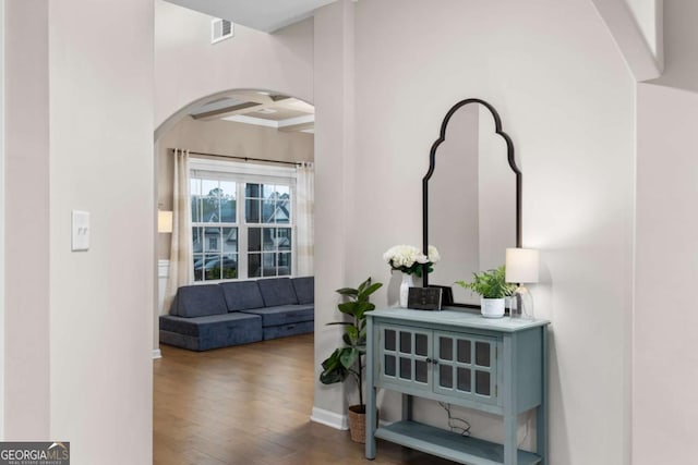 hallway featuring beamed ceiling, wood-type flooring, and coffered ceiling