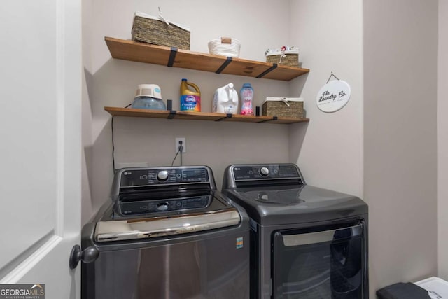 clothes washing area featuring independent washer and dryer