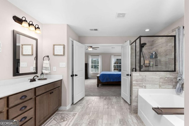 bathroom featuring independent shower and bath, vanity, and ceiling fan