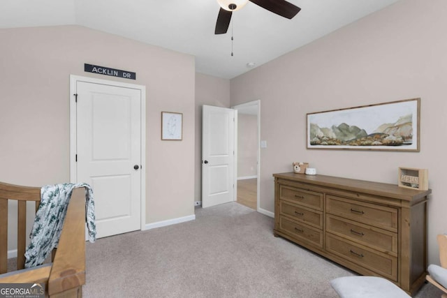 carpeted bedroom with vaulted ceiling and ceiling fan