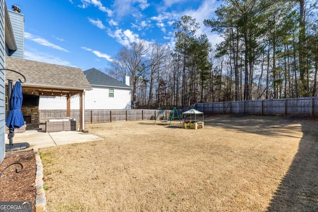 view of yard with a playground and a patio area