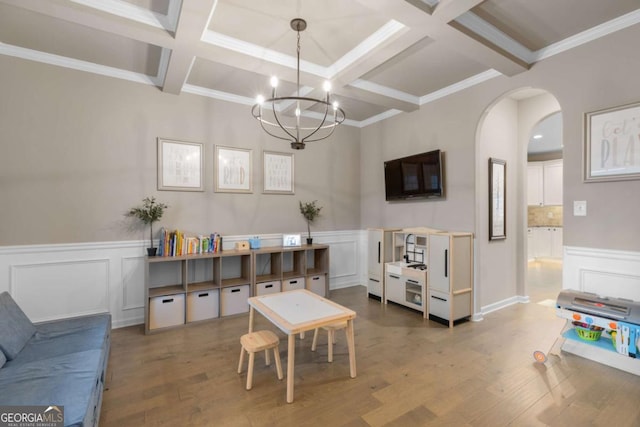 living room with hardwood / wood-style flooring, ornamental molding, coffered ceiling, and beamed ceiling