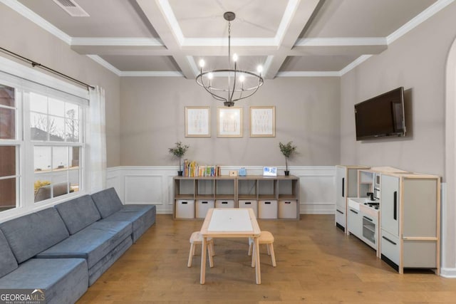 living room featuring coffered ceiling, beam ceiling, a chandelier, and light wood-type flooring