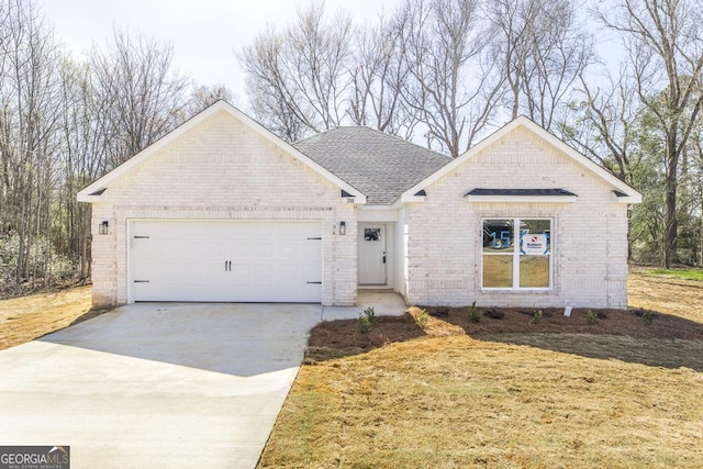 ranch-style house featuring an attached garage, roof with shingles, concrete driveway, and brick siding