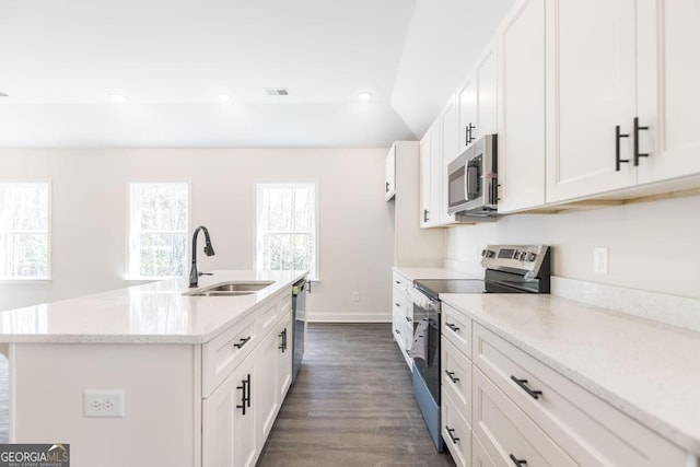 kitchen featuring an island with sink, white cabinetry, appliances with stainless steel finishes, and a sink