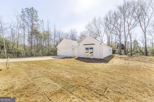 view of home's exterior with a garage and a lawn