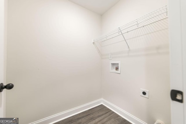 laundry room featuring laundry area, baseboards, dark wood-type flooring, hookup for a washing machine, and hookup for an electric dryer