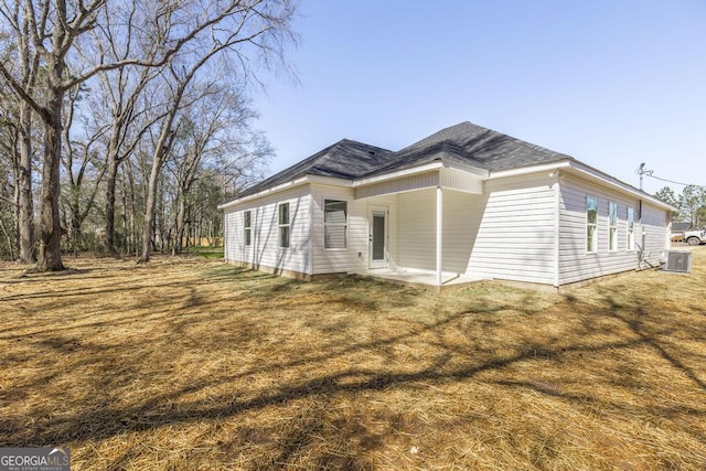 view of home's exterior with central AC, a yard, and a patio area