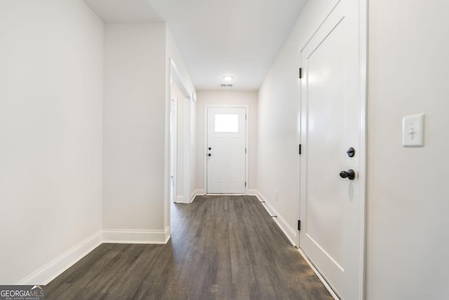 doorway to outside featuring visible vents, dark wood finished floors, and baseboards