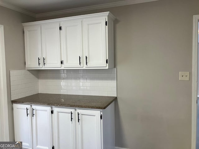 kitchen featuring white cabinetry, crown molding, and decorative backsplash