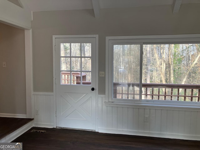 entryway with a healthy amount of sunlight, dark wood-type flooring, and beam ceiling