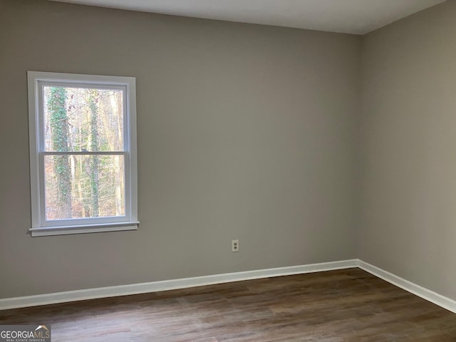 empty room with dark hardwood / wood-style floors