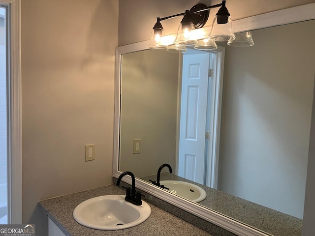 bathroom with vanity and a notable chandelier