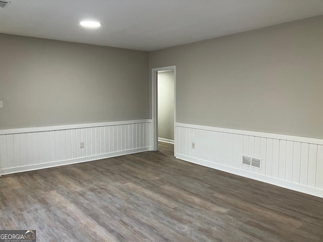 spare room with dark wood-type flooring