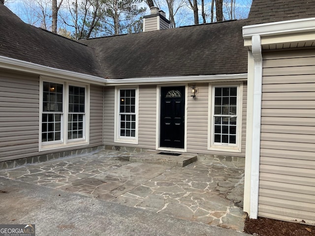 entrance to property featuring a patio