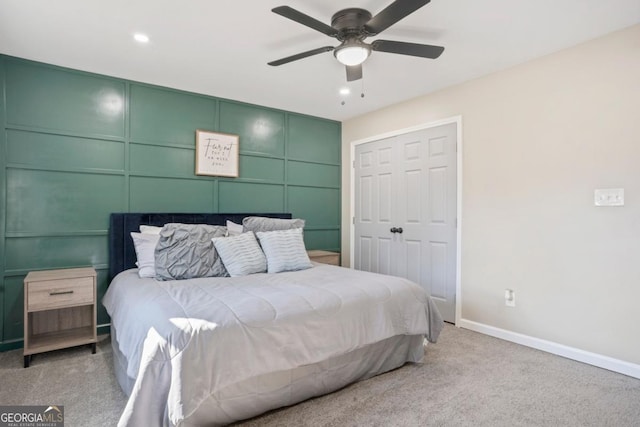 bedroom featuring ceiling fan, a closet, and light carpet