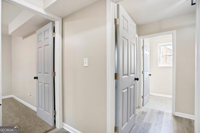 hall with light hardwood / wood-style floors