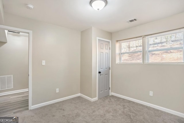 empty room featuring light colored carpet