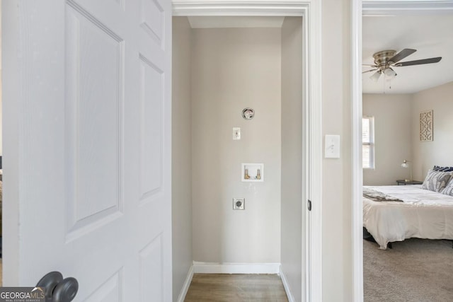 interior space with ceiling fan, washer hookup, hookup for an electric dryer, and light carpet