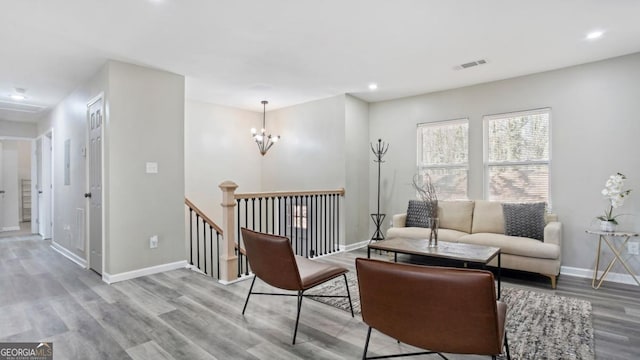 living area featuring a notable chandelier and light wood-type flooring