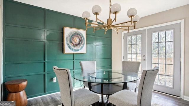 dining room featuring dark hardwood / wood-style floors, french doors, and a chandelier