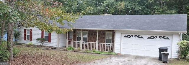 single story home featuring a porch and a garage