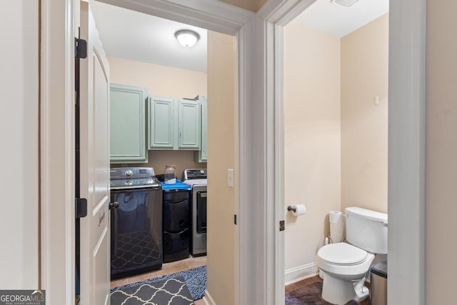 bathroom with independent washer and dryer and toilet