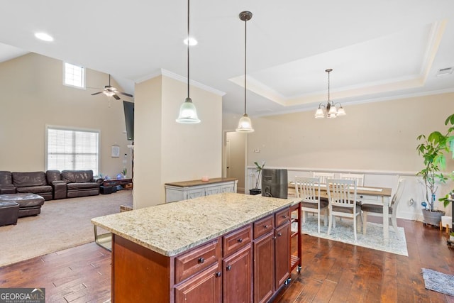 kitchen featuring a center island, pendant lighting, and light stone counters