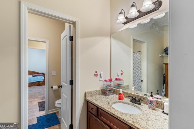 bathroom featuring vanity and toilet