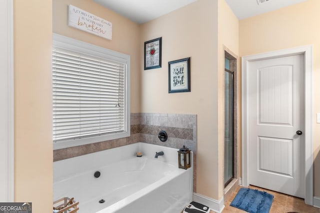 bathroom with separate shower and tub and tile patterned flooring