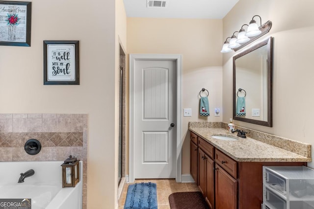 bathroom with tile patterned flooring, vanity, and plus walk in shower