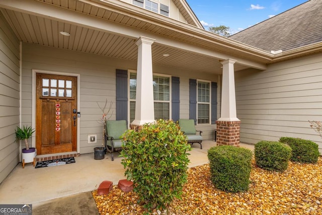 view of exterior entry featuring a porch