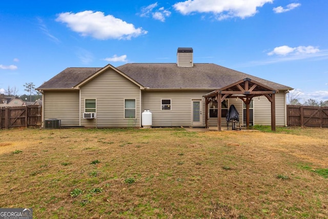 back of house featuring a gazebo, central AC unit, a lawn, cooling unit, and a patio