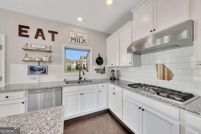 kitchen featuring sink, stainless steel appliances, dark hardwood / wood-style floors, light stone counters, and white cabinets