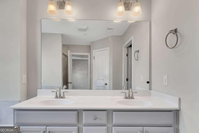 bathroom featuring walk in shower, vanity, and a notable chandelier