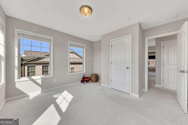 bedroom featuring light colored carpet