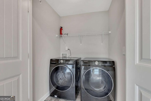 laundry area with washing machine and clothes dryer