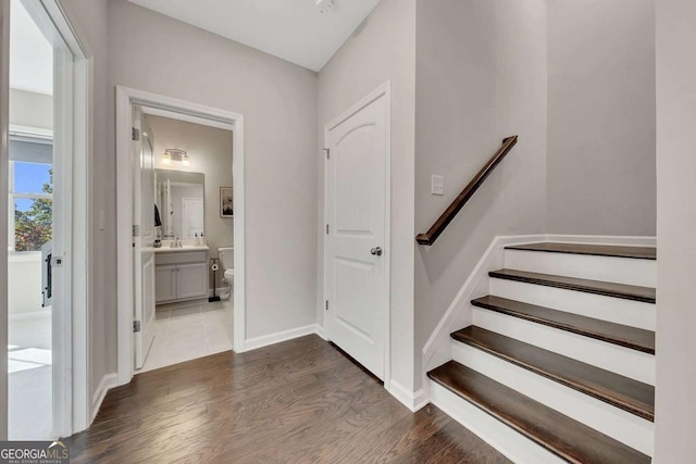 stairs with sink and hardwood / wood-style flooring