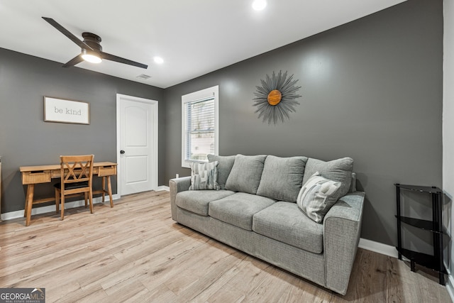 living room featuring ceiling fan and light hardwood / wood-style floors