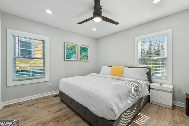 bedroom with light hardwood / wood-style flooring and ceiling fan