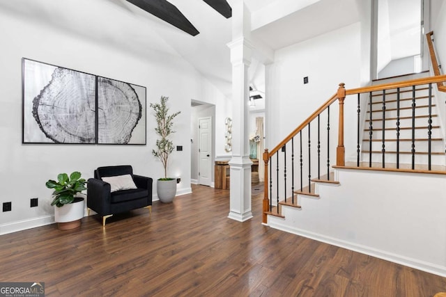 foyer featuring decorative columns and dark hardwood / wood-style floors