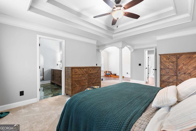 bedroom featuring crown molding, carpet floors, a raised ceiling, and ornate columns