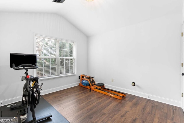 exercise area featuring lofted ceiling and dark hardwood / wood-style floors